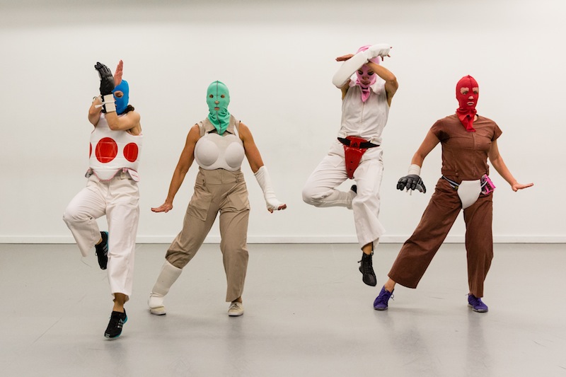 Four women wear wrestling masks